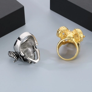 Macro detail of gothic ram skull rings in silver and gold finishes with metal textures