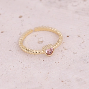Detailed macro view of a gold-plated adjustable ring featuring a heart-shaped pink zircon stone