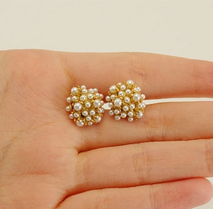 Macro view of vintage style 18k gold plated pearl cluster stud earrings for women