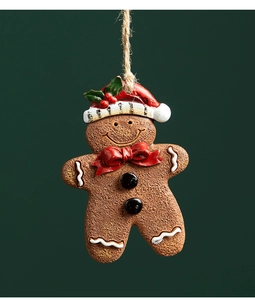 Close-up of resin gingerbread man ornament with red hat and rustic hemp rope hanger