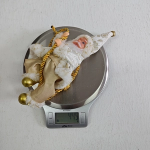 Detail showing Santa Claus figurine weight measurement of 44.5g on a digital scale