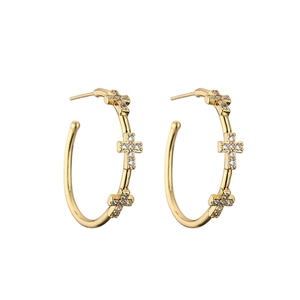 Golden C-shaped earrings with micro-pave zircon cross pattern on a clean white background