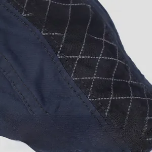 Detailed close-up of a quilted vintage cotton newsboy cap with grey contrast stitching