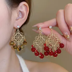 Bohemian hollow gold earrings with tiger eye beads and crystals for a retro court style look
