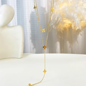 Elegant gold titanium Y-necklace with clover-shaped charms and bead pendant for women