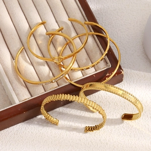 Detail of 18K gold-plated stainless steel hollow heart bracelets and zircon bangles