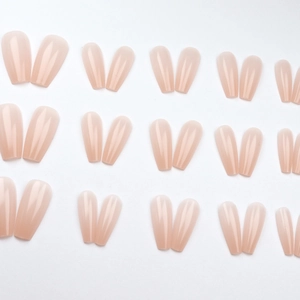 Glossy nude pink press-on nails in long coffin shape displayed in full size range set
