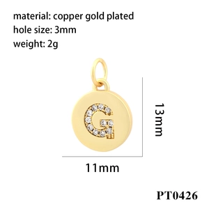 Detail view of 18K gold plated copper circle pendant with cubic zirconia letter G