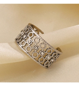Macro shot of retro镂空 hollow ring with crystal inlay on soft satin background