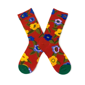 Detailed view of red cotton socks with colorful blue, yellow, and purple floral patterns