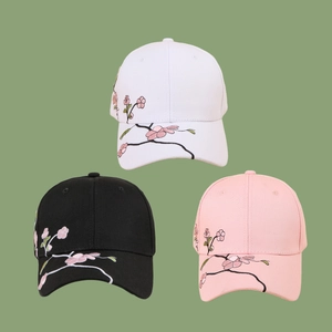 Three cotton baseball caps in black, white, and pink with cherry blossom embroidery