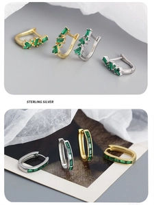 Detail of emerald gemstone earrings in gold and silver sterling silver with 925 hallmarks