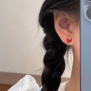 Exquisite red strawberry stud earrings with gold leaf and small diamonds on ear model