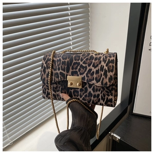 Detail of leopard print shoulder bag with gold chain strap and rectangular metallic clasp