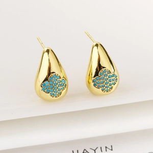 Detail of teardrop earrings with blue clover inlay on white geometric stands
