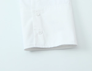 Detailed close-up of double-button white shirt cuffs with high-density stitching