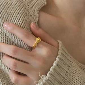 Elegant 925 sterling silver bow ring in gold finish worn by a model in Korean style