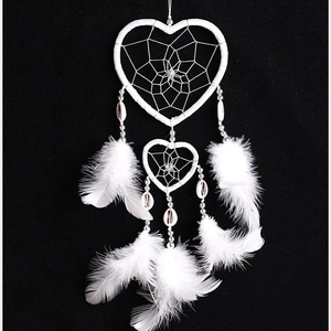 White heart-shaped dreamcatcher with woven mesh, shell beads and soft feathers