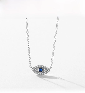 Macro detail of S925 sterling silver evil eye pendant with blue and white zircon stones