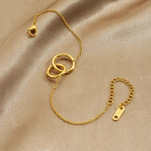 Elegant gold-plated stainless steel interlocking double-ring bracelet on champagne silk cloth