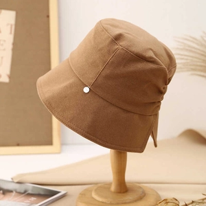 Elegant caramel brown bucket hat with bow and silver charm for sun protection