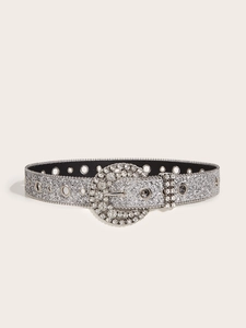 Detailed view of silver glitter belt featuring a rhinestone-encrusted round metal buckle