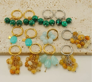 Detail of 18k gold earrings collection featuring malachite and natural stones