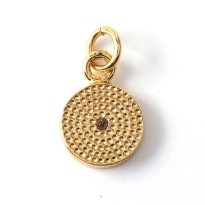 Detailed view of sun moon charm with gold texture and centered brown stone inlay