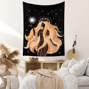 Detailed close-up of Bohemian starry goddess tapestry hanging over a bedroom bed