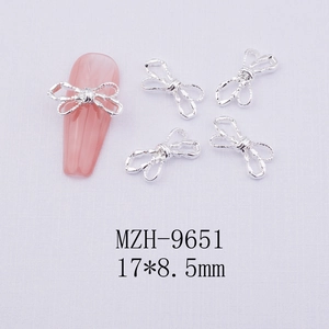 Silver hollow bow nail art charms with dimensions 17x8.5mm for DIY manicure design