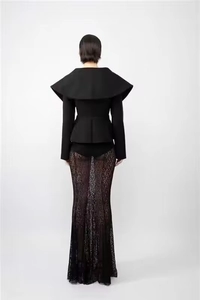 Detail view of the back showing a structured black waist-defining coat with a large lapel