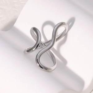 Macro detail of silver abstract criss-cross line ring with a polished minimalist finish