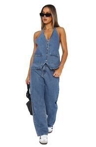 Detail of blue denim halter vest featuring V-neckline and metal buttons closure