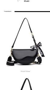 Front view of black saddle bag with asymmetric wave flap and stylish patterned scarf
