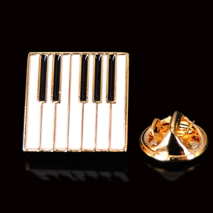 Elegant gold-trimmed piano keyboard enamel brooch with black and white musical theme