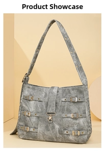 Close-up of grey washed fabric tote bag featuring industrial buckle straps and lobster clasp