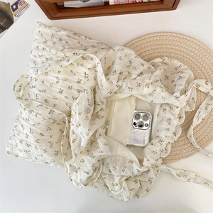 Detail of floral chiffon tote bag showing a secure inner zipper pocket and lining