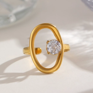 Detailed shot of an adjustable gold-plated ring with a central zircon in an oval frame