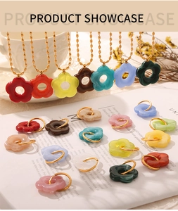 Detailed close-up of colorful resin flower pendant necklaces with gold ball chains