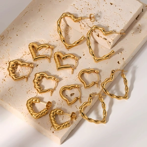 Variety of 18k gold plated heart earrings in bamboo and smooth textures on stone