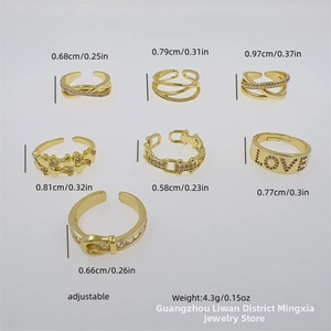 Detail view of 7 adjustable gold rings set with zircon heart and LOVE letter motifs