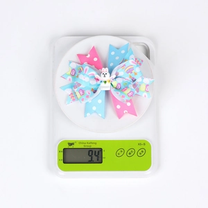 Easter multi-layer ribbon bow hair clip with bunny doll and printed eggs showing 9.4g weight