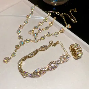 Elegant gold necklace bracelet and ring set featuring colorful aurora rhinestones