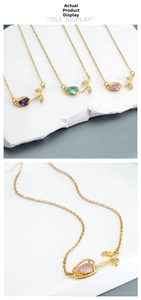 Macro shot of tulip-shaped zircon pendants with pear-cut gems in purple and pink