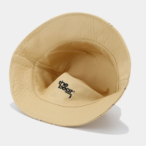 Detail of the inner lining of a beige cotton sun hat with black 'the bear' letter print