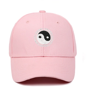 Close-up of the Tai Chi Yin Yang embroidery and Swimming text on the pink cotton baseball cap