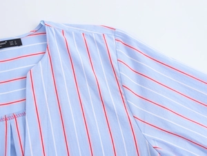 Detail of blue striped shirt neckline showing the size label and fabric texture