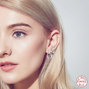 S925 sterling silver hoop earrings set with moon star charms and shimmering pavé zircons