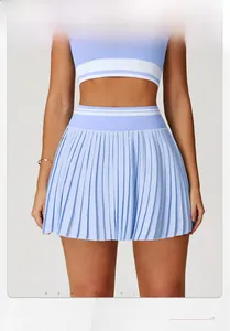 Close-up of light blue high-waist pleated tennis skirt with white waist stripe details