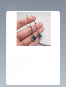 Detailed view of long tassel earrings with blue zircon teardrop pendant, 6.0cm length